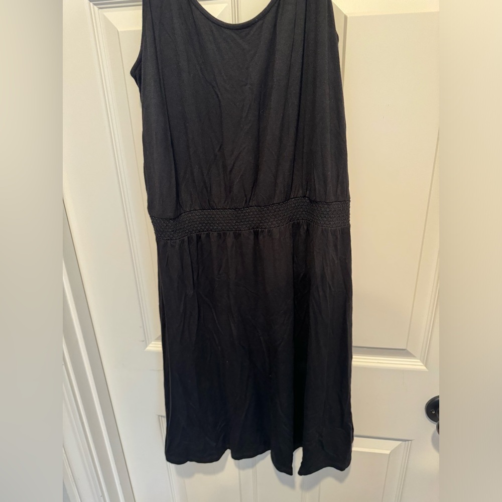 New with tags black dress with braided waist band fit and flare style Medium.